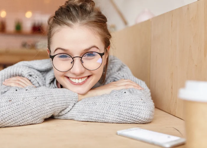 indoor-shot-dreamy-adorable-woman-wearing-round-spectacles-min